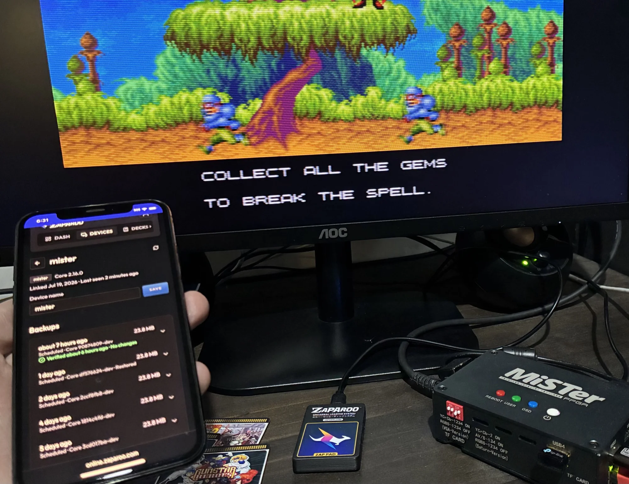 MiSTer running a game beside a phone showing Zaparoo Online backups