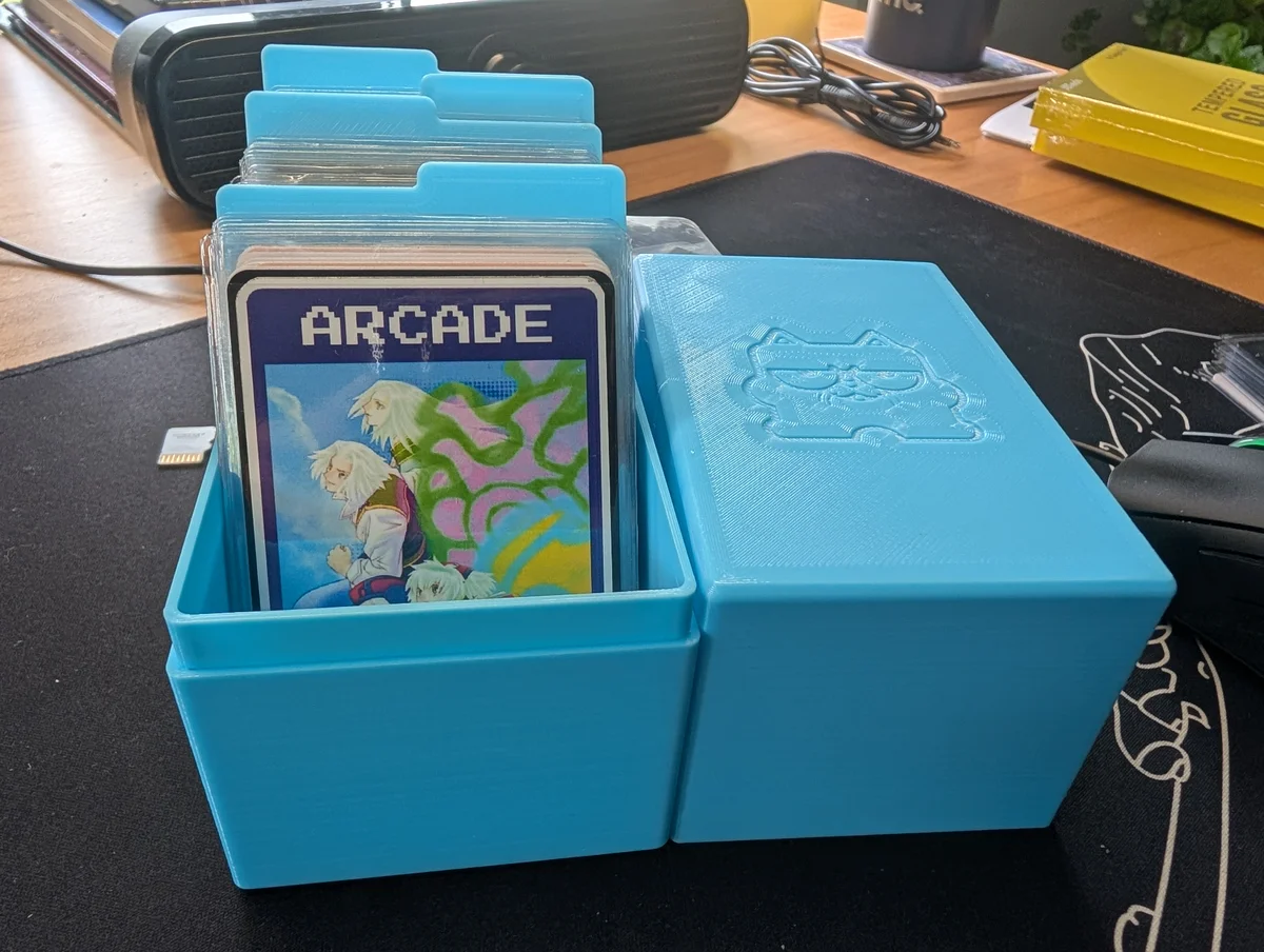 Printed card box filled with sleeved game cards and tabbed dividers